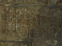 Stone carvings on a wall in the foundations of the original church on the site